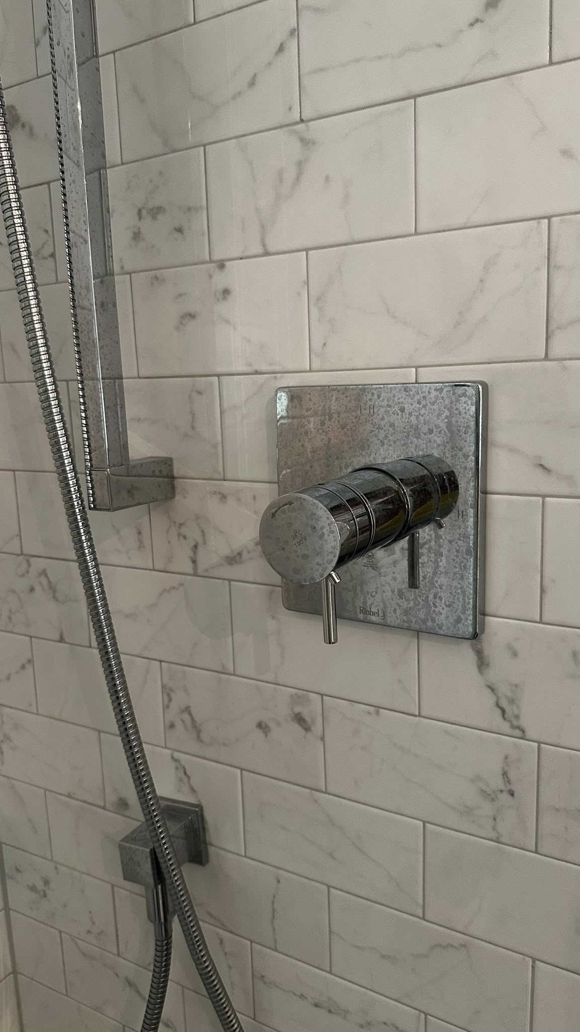 Shower fixture shine before cleaning